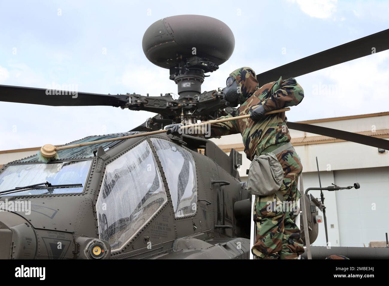 Soldiers from 23rd Chemical Battalion, 2nd Infantry Division Sustainment Brigade lead a class on decontamination of an AH-64E v6 Apache helicopter. The Soldiers from 4-2 Attack Battalion, 2nd Combat Aviation Brigade were able to get a hands on experience of using the M26 decontamination apparatus to spray down the helicopter. Stock Photo