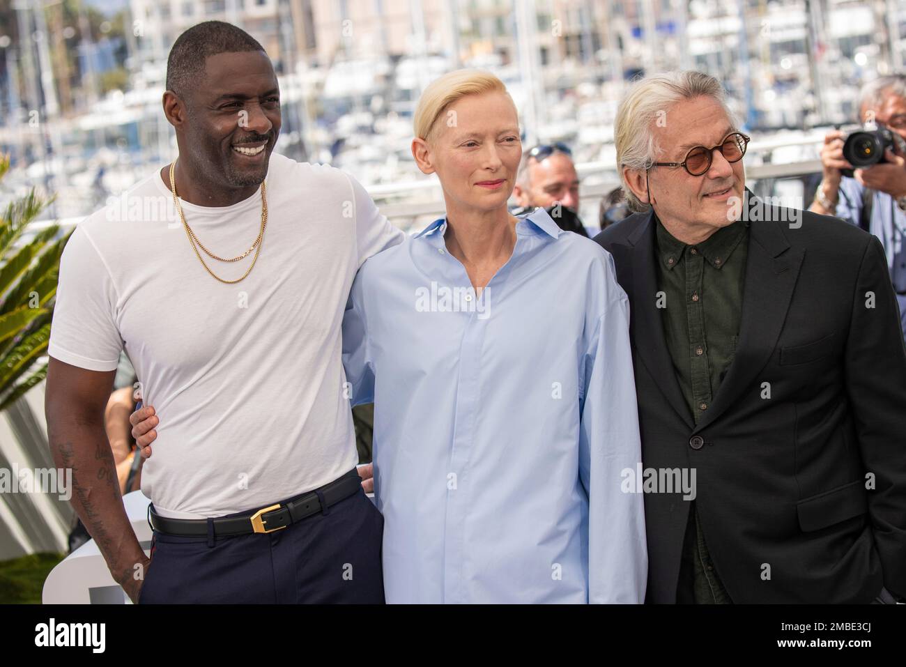 Idris Elba, Tilda Swinton, and director Miller pose for