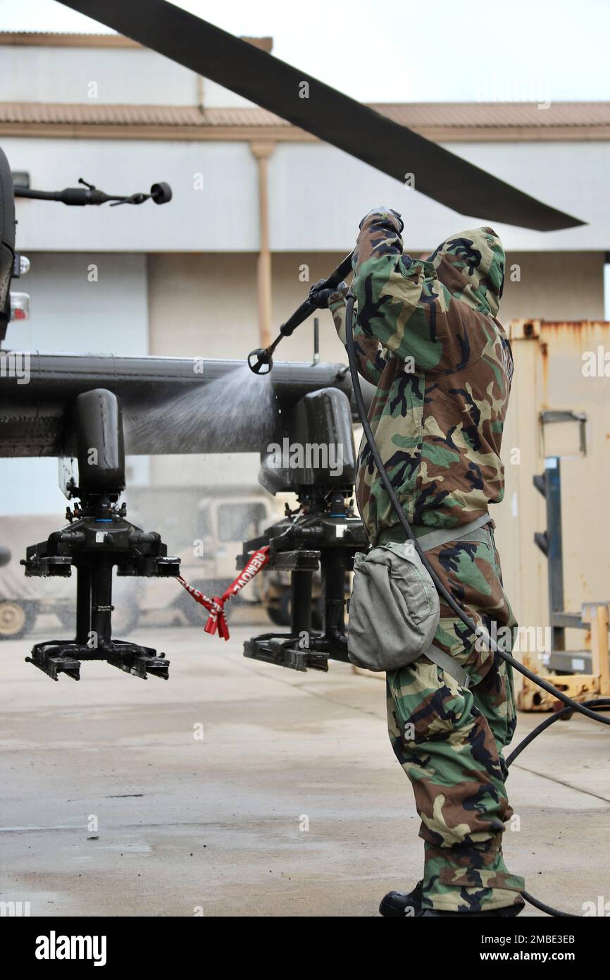 Soldiers from 23rd Chemical Battalion, 2nd Infantry Division Sustainment Brigade lead a class on decontamination of an AH-64E v6 Apache helicopter. The Soldiers from 4-2 Attack Battalion, 2nd Combat Aviation Brigade were able to get a hands on experience of using the M26 decontamination apparatus to spray down the helicopter. Stock Photo