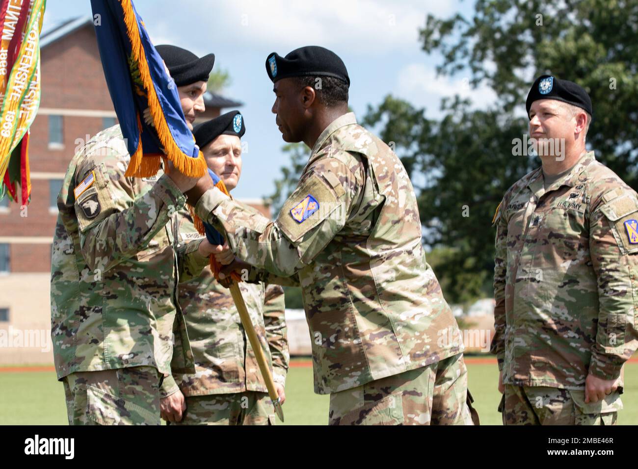 U.S. Army Lt. Col Steven Conrad, 1st Battalion, 222d Aviation Regiment, passes the colors to Col. Jake Miller, 128th Aviation Brigade commander, during a battalion change of command ceremony June 15, 2022. Stock Photo