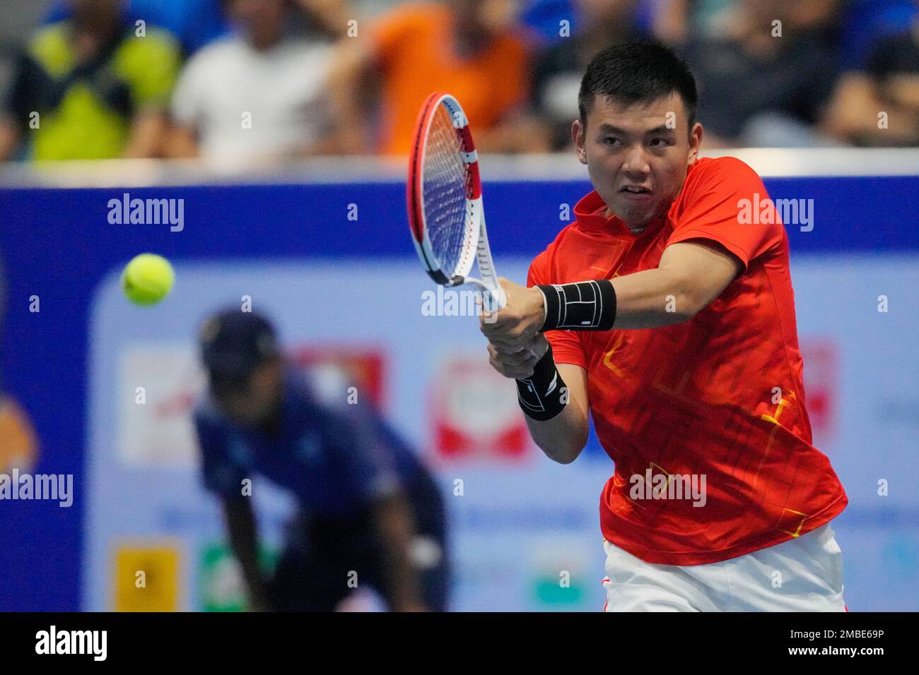 Nam Hoang Ly of Vietnam returns a ball to Yuttana Charoenphon of Thailand during their mens singles semi-final tennis match at the 31st Southeast Asian Games (SEA Games 31) in Bac Ninh,