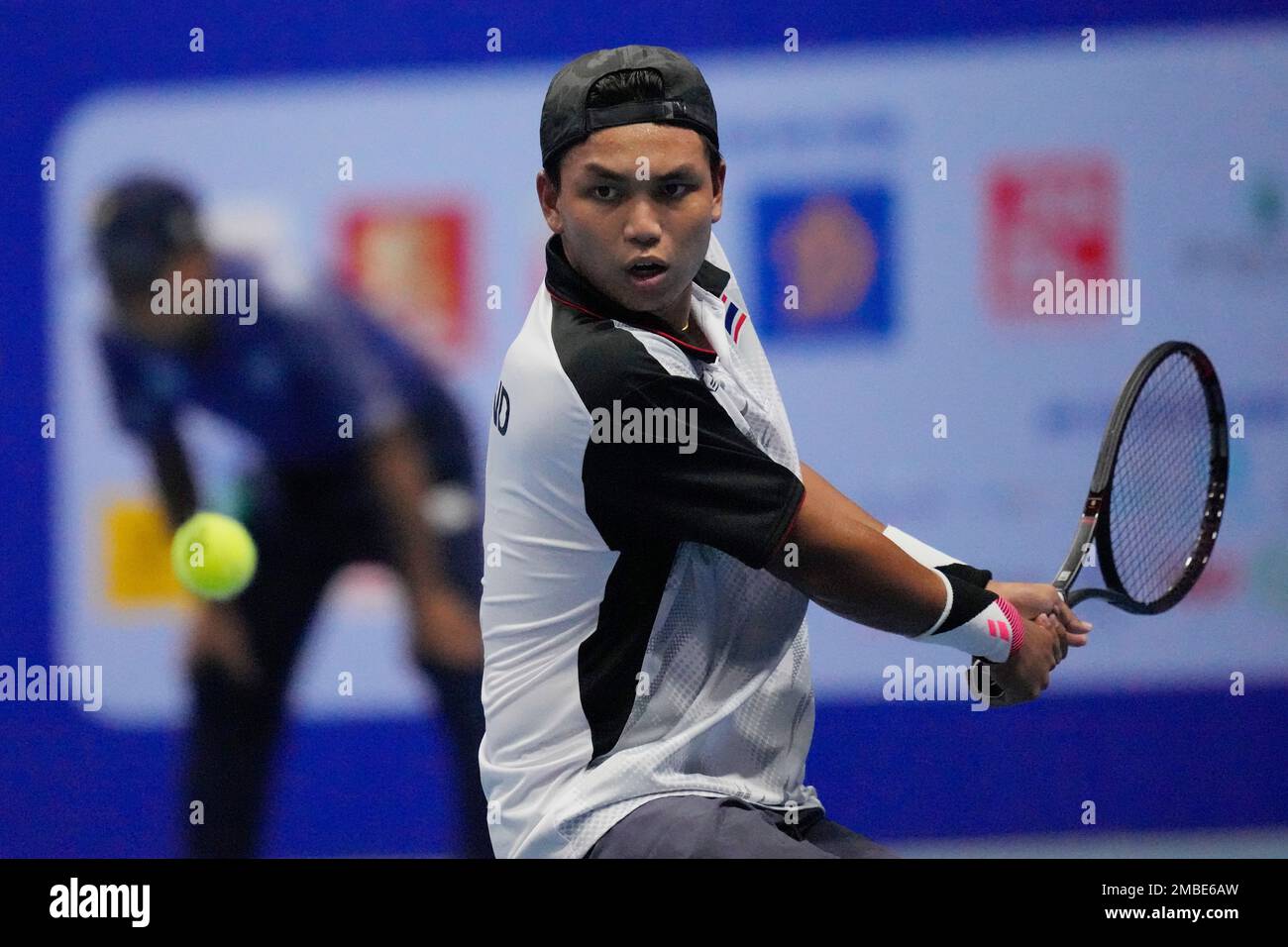 Yuttana Charoenphon of Thailand returns a ball to Nam Hoang Ly of Vietnam during their mens singles semi-final tennis match at the 31st Southeast Asian Games (SEA Games 31) in Bac Ninh,
