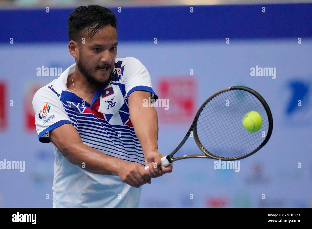 Mick Lescure Sadettan of Laos returns a ball to Giang Trinh Linh of Vietnam  during their men's singles semi-final tennis match at the 31st Southeast  Asian Games (SEA Games 31) in Bac