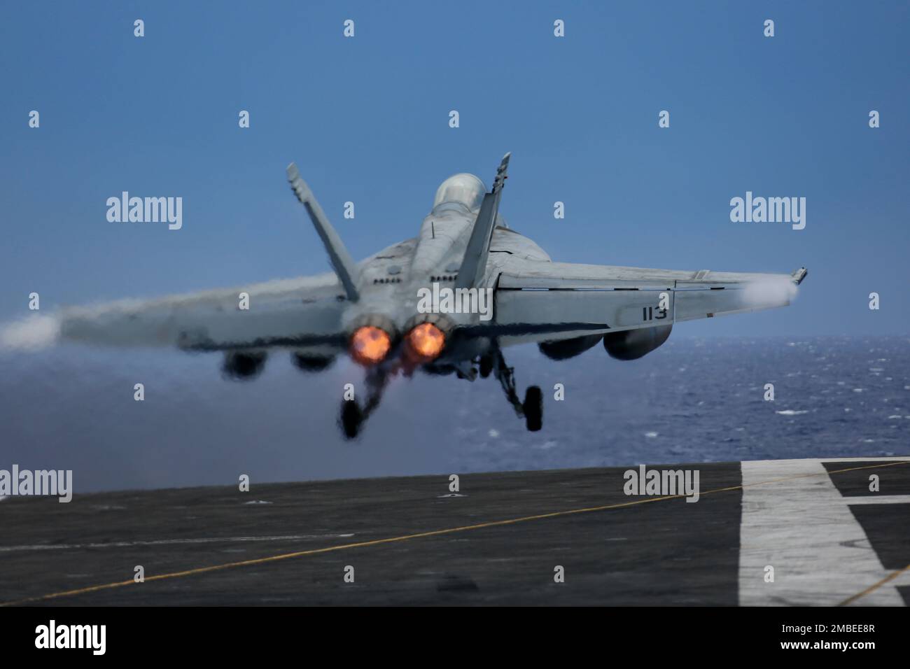 PHILIPPINE SEA (June 15, 2022) An F/A-18F Super Hornet, assigned to the 'Black Aces' of Strike Fighter Squadron (VFA) 41, launches from the flight deck of the Nimitz-class aircraft carrier USS Abraham Lincoln (CVN 72). Abraham Lincoln Strike Group is on a scheduled deployment in the U.S. 7th Fleet area of operations to enhance interoperability through alliances and partnerships while serving as a ready-response force in support of a free and open Indo-Pacific region. Stock Photo