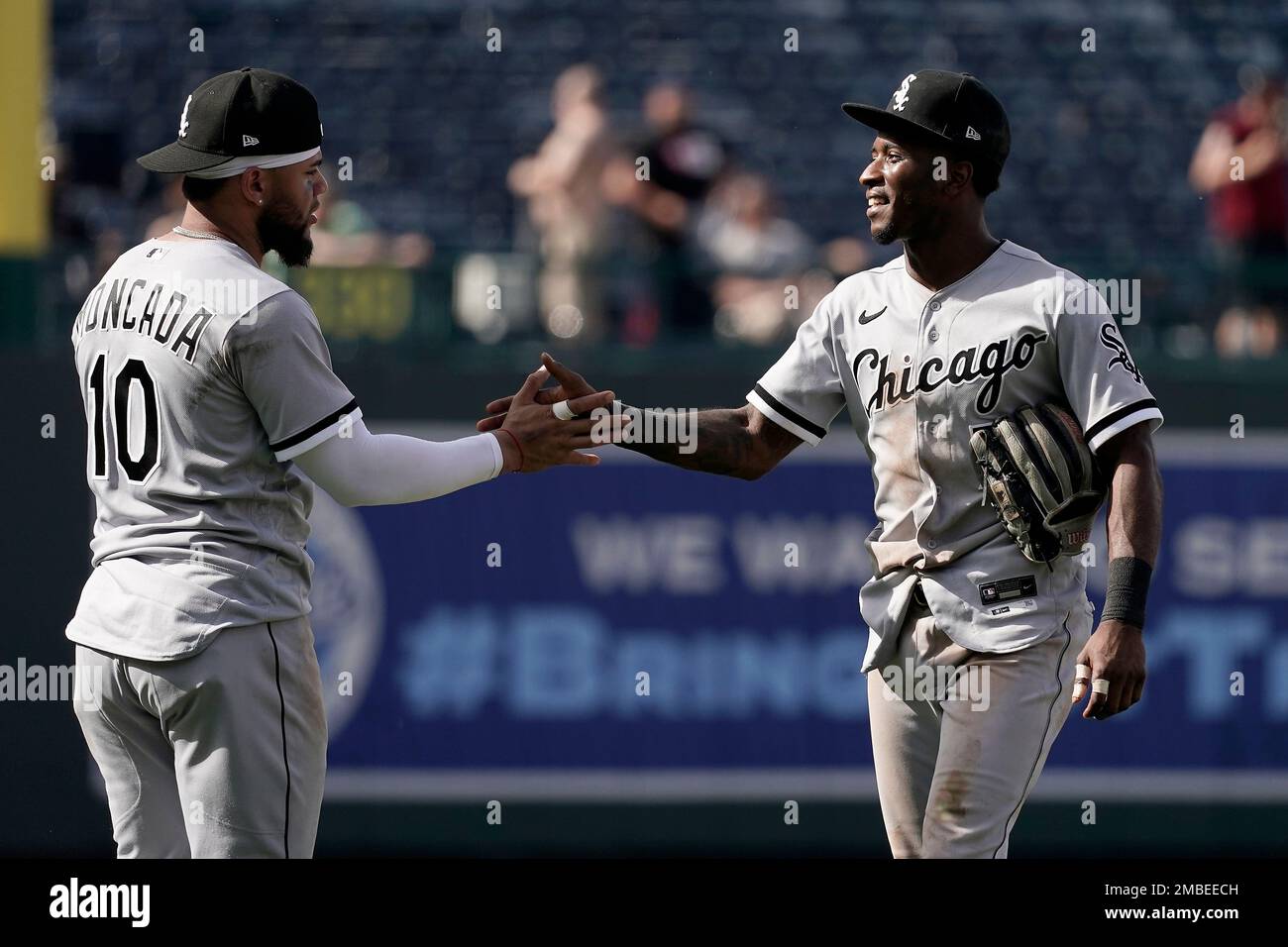 Chicago White Sox's Yoan Moncada (10) and Tim Anderson celebrate after  their baseball game against the Kansas City Royals Thursday, May 19, 2022,  in Kansas City, Mo. The White Sox won 7-4. (
