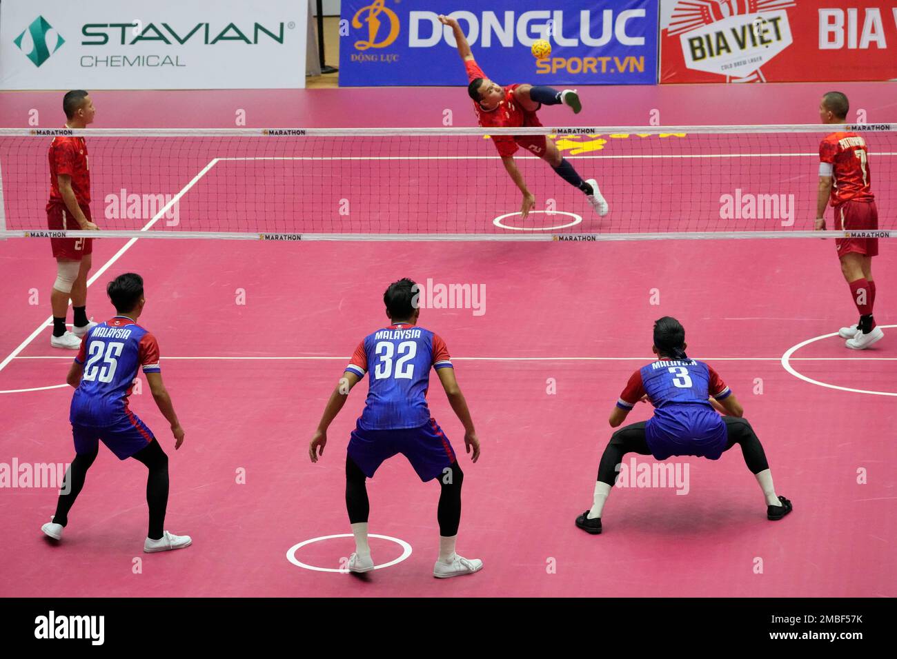 Siriwat Sakha of Thailand, left, center, kick a ball during the final mens regu Sepaktakraw match between Thailand and Malaysia at the 31st Southeast Asian Games (SEA Games 31) in Hanoi, Vietnam,