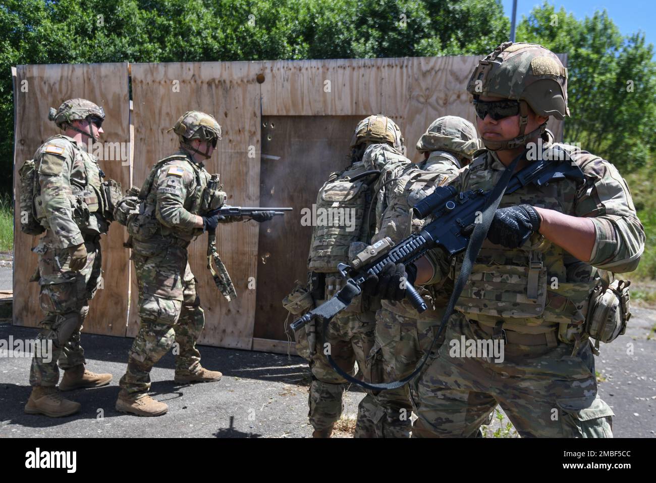 U.S. Soldiers, assigned to Bull Troop, 1st Squadron, 2nd Cavalry Regiment (2CR), use a shotgun to breach a door during a demolition/breaching range at the 7th Army Training Command's (7ATC) Grafenwoehr Training Area, Germany, June 15, 2022. 2CR provides the 7th ATC with a lethal and agile force capable of rapid deployment throughout the European theater in order to assure allies, deter adversaries, and when ordered, defend the NATO alliance. Stock Photo