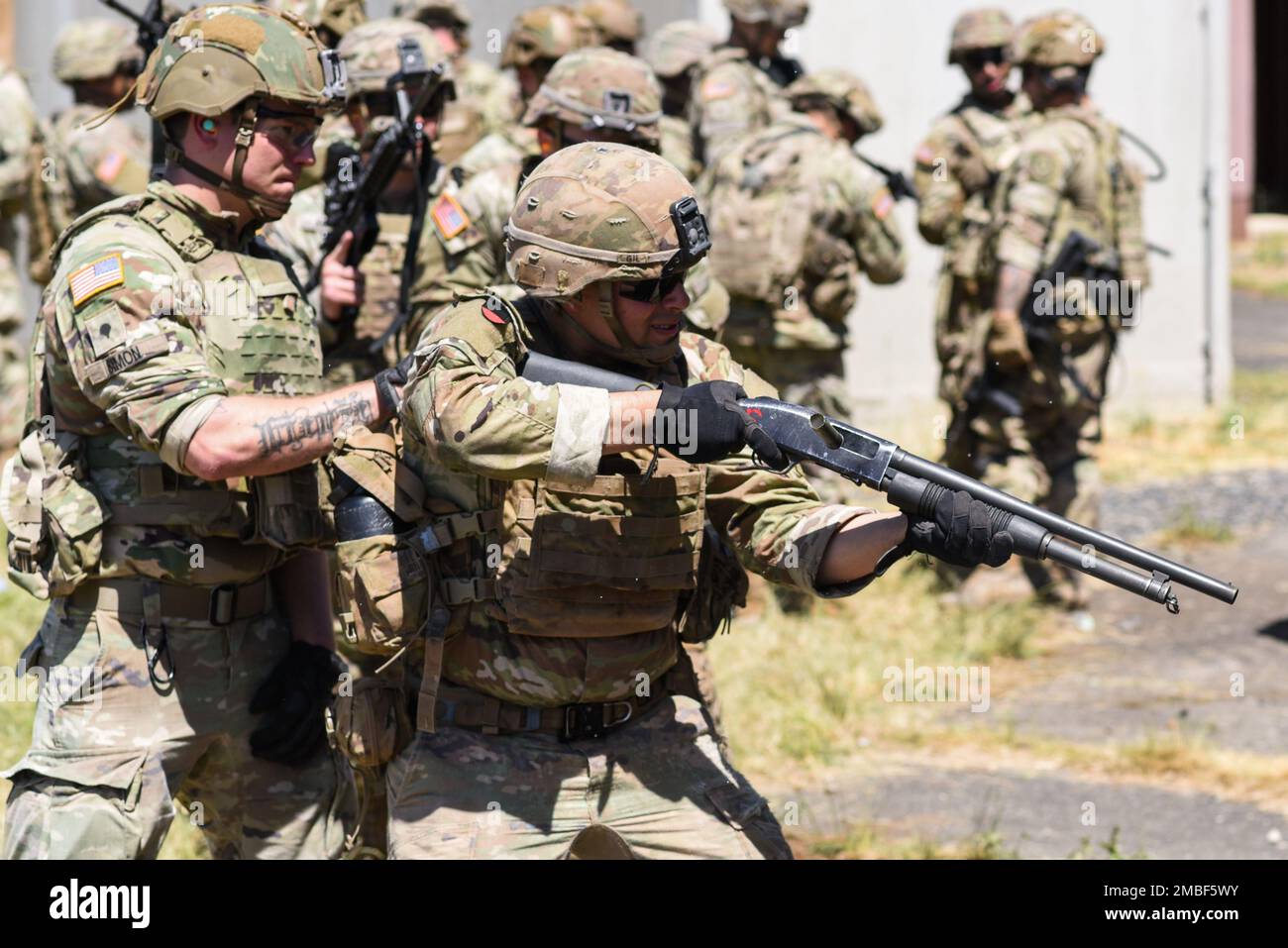 A U.S. Soldier, assigned to Bull Troop, 1st Squadron, 2nd Cavalry Regiment (2CR), fires a shotgun to breach a door during a demolition/breaching range at the 7th Army Training Command's (7ATC) Grafenwoehr Training Area, Germany, June 15, 2022. 2CR provides the 7th ATC with a lethal and agile force capable of rapid deployment throughout the European theater in order to assure allies, deter adversaries, and when ordered, defend the NATO alliance. Stock Photo