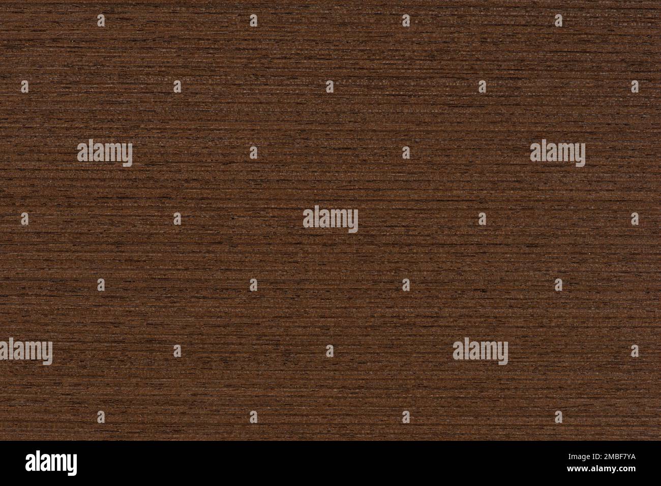 Texture of wenge wood. Dark brown wood for furniture or flooring. Close-up of a Wenge wooden ...