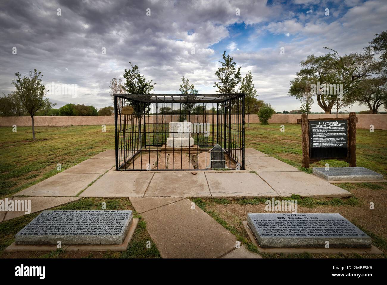 The black stone is the grave of Henry McCarty, aka William H. Bonney, and Billy the Kid at the Old Fort Sumner Cemetery in Fort Sumner, New Mexico. Stock Photo