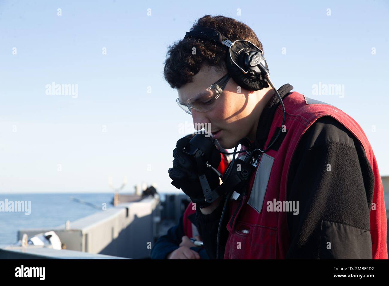 Aviation Ordnanceman Airman William Cauldwell, from Fishers, Indiana, assigned to USS Gerald R. Ford's (CVN 78) weapons, uses a sound-powered telephone to clear green range for the MK 38 - 25 mm machine gun system for inspection, June 15, 2022. Ford is underway in the Atlantic Ocean conducting a Board of Inspection and Survey (INSURV) assessment to report ship readiness and ensure all spaces and equipment meet Navy Standards. Stock Photo