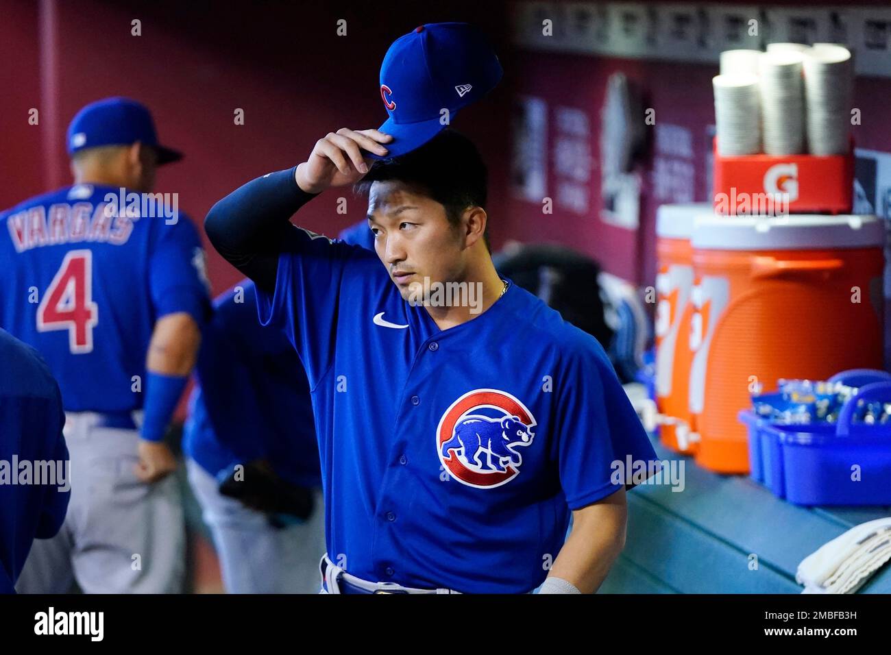 Chicago Cubs' Seiya Suzuki, of Japan, adjusts his hat as he pauses in the  dugout prior to a baseball game against the Arizona Diamondbacks Sunday,  May 15, 2022, in Phoenix. (AP Photo/Ross