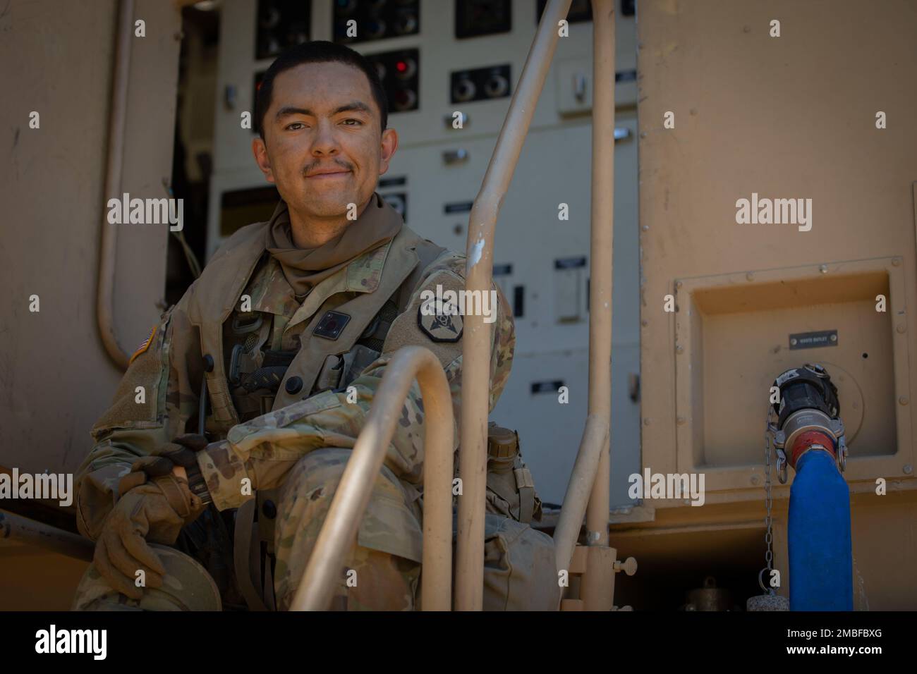 Army Reserve Cpl. Brandon Vickers, a water treatment specialist assigned to the 651st Quartermaster Company based in Casper, Wyoming, poses for a photo next to a reverse osmosis water purification unit during Combat Support Training Exercise 91-22-01 at Fort Hunter Liggett, California, June 15. During the exercise Vickers, along with other Soldiers from his unit, will provide thousands of gallons of clean water for showers, personal hygiene and laundry, providing the opportunity for Army Reserve Soldiers in the field exercise to stay clean and wash their gear. Stock Photo