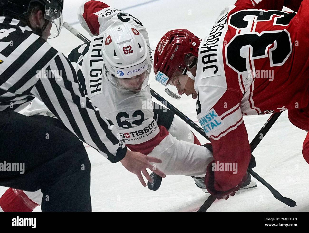 Denis Malgin of Switzerland, left, and Denmarks Julian Jakobsen watch the puck during the group A Hockey World Championship match between Denmark and Switzerland in Helsinki, Finland, Sunday May 15, 2022