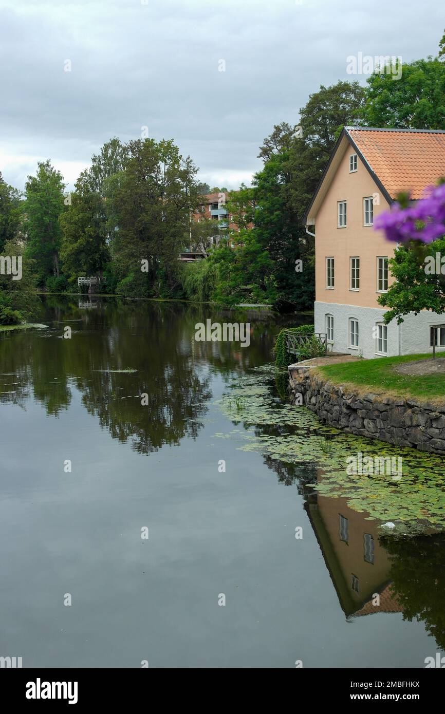Scenic view of lake by building against sky Stock Photo - Alamy