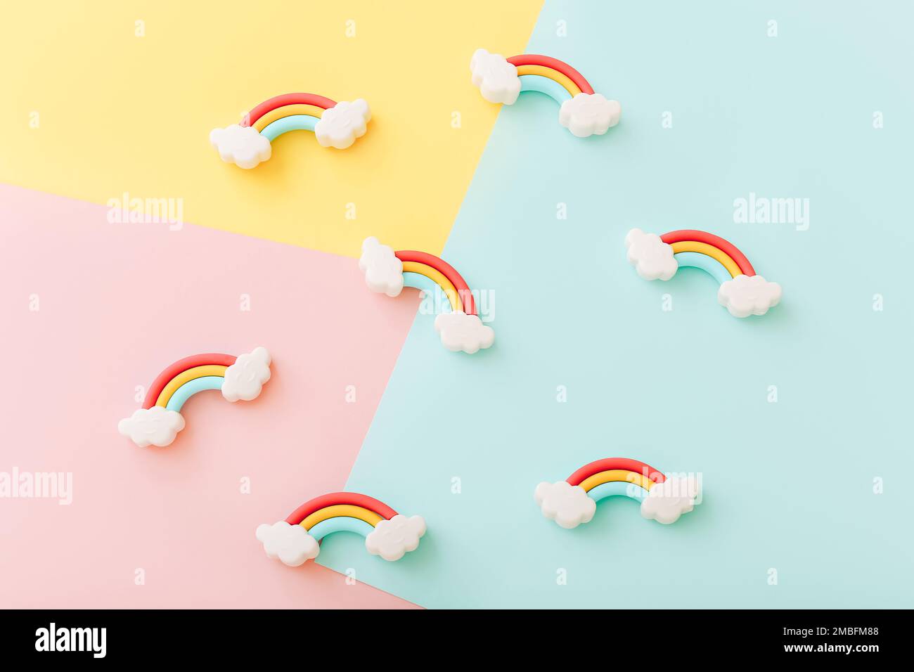 Rainbow erasers with smiling clouds on color background, top view Stock Photo