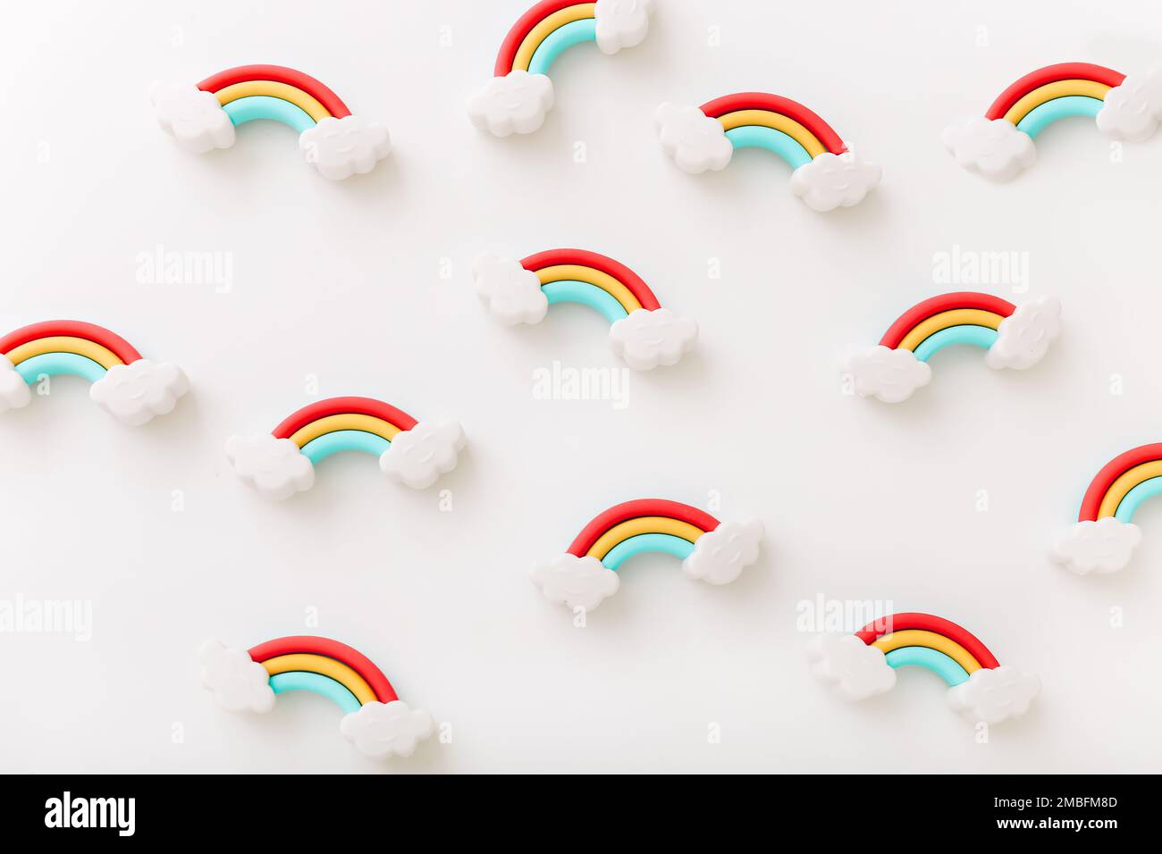 Rainbow erasers with smiling clouds on white background, top view Stock Photo