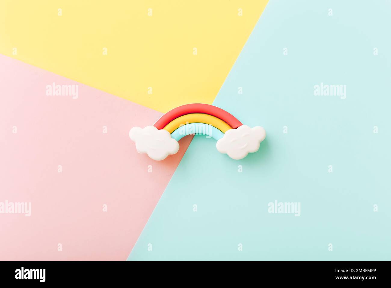 Rainbow erasers with smiling clouds on color background, top view Stock Photo