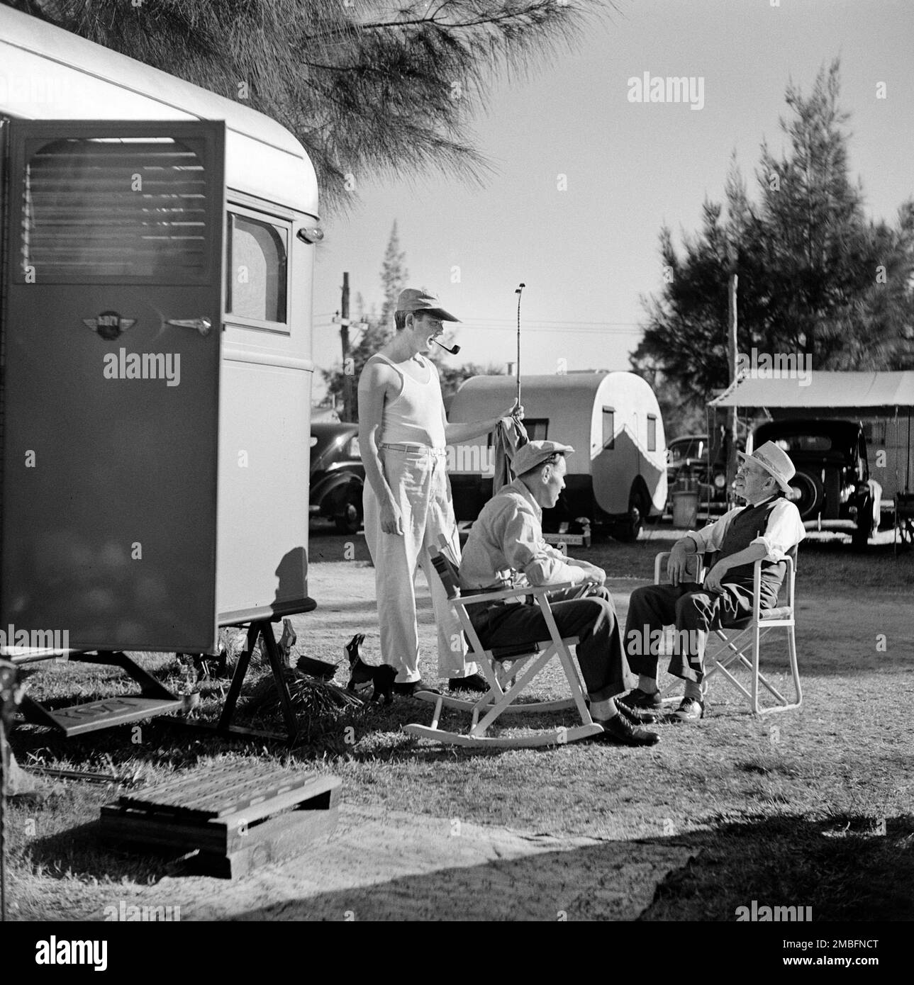 Three Men having Conversation at Trailer Park, Sarasota, Florida, USA, Marion Post Wolcott, U.S. Farm Security Administration, January 1941 Stock Photo