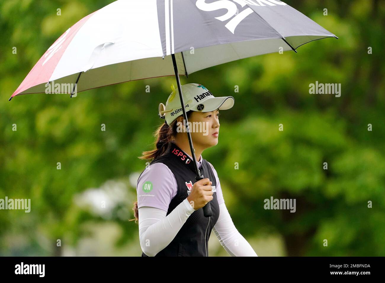 Minjee Lee walks with an umbrella onto the eighth tee during the third  round of the LPGA Cognizant Founders Cup golf tournament, Saturday, May 14,  2022, at the Upper Montclair Country Club