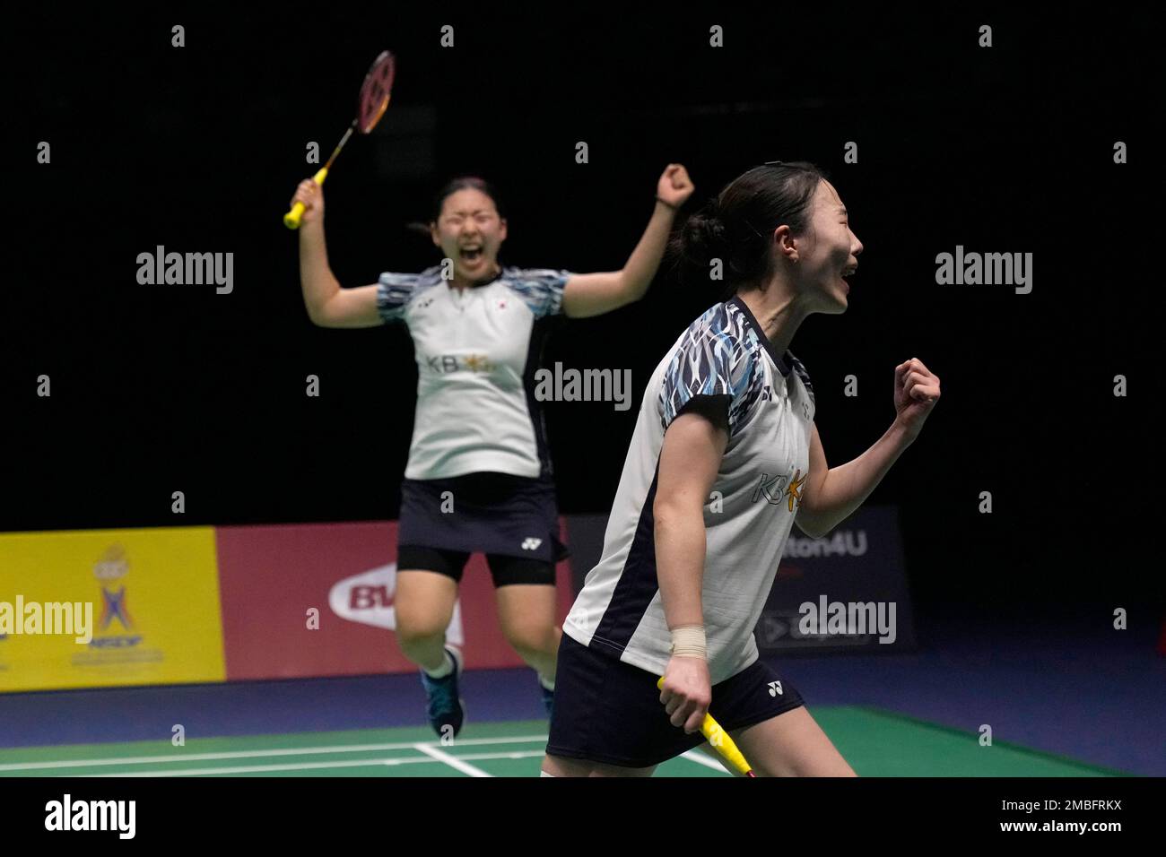 South Koreas Kong Hee-yong, left, and Kim Hye-jeong react after winning over Chinas Huang Dong Ping and Li Wen Mei during their womens double final badminton match at Thomas and Uber Cup