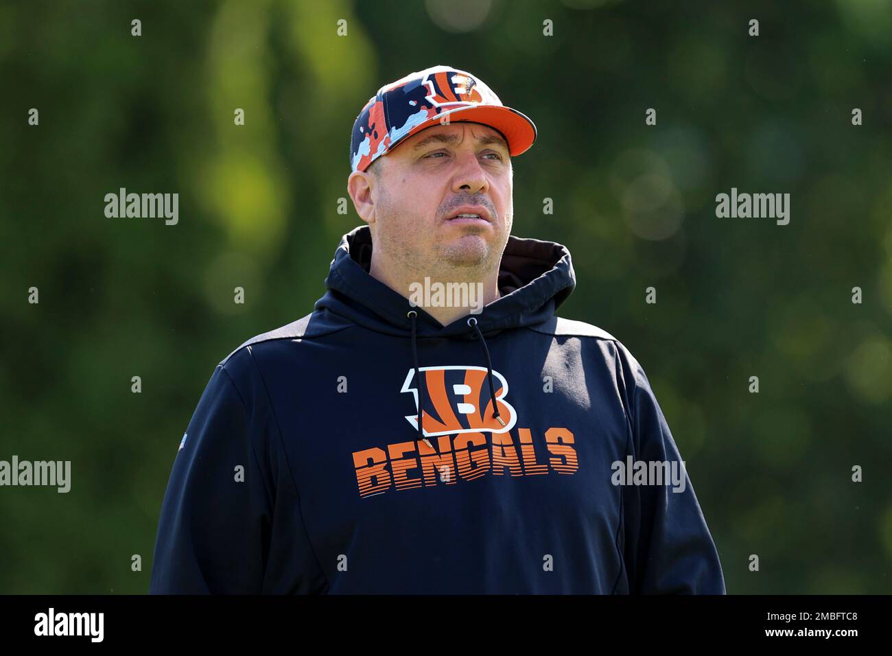 Cincinnati Bengals' equipment manager Adam Knollman walks on the field