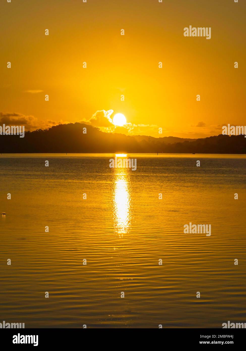 Orange sunrise over Brisbane Water at Koolewong and Tascott on the Central Coast, NSW, Australia. Stock Photo