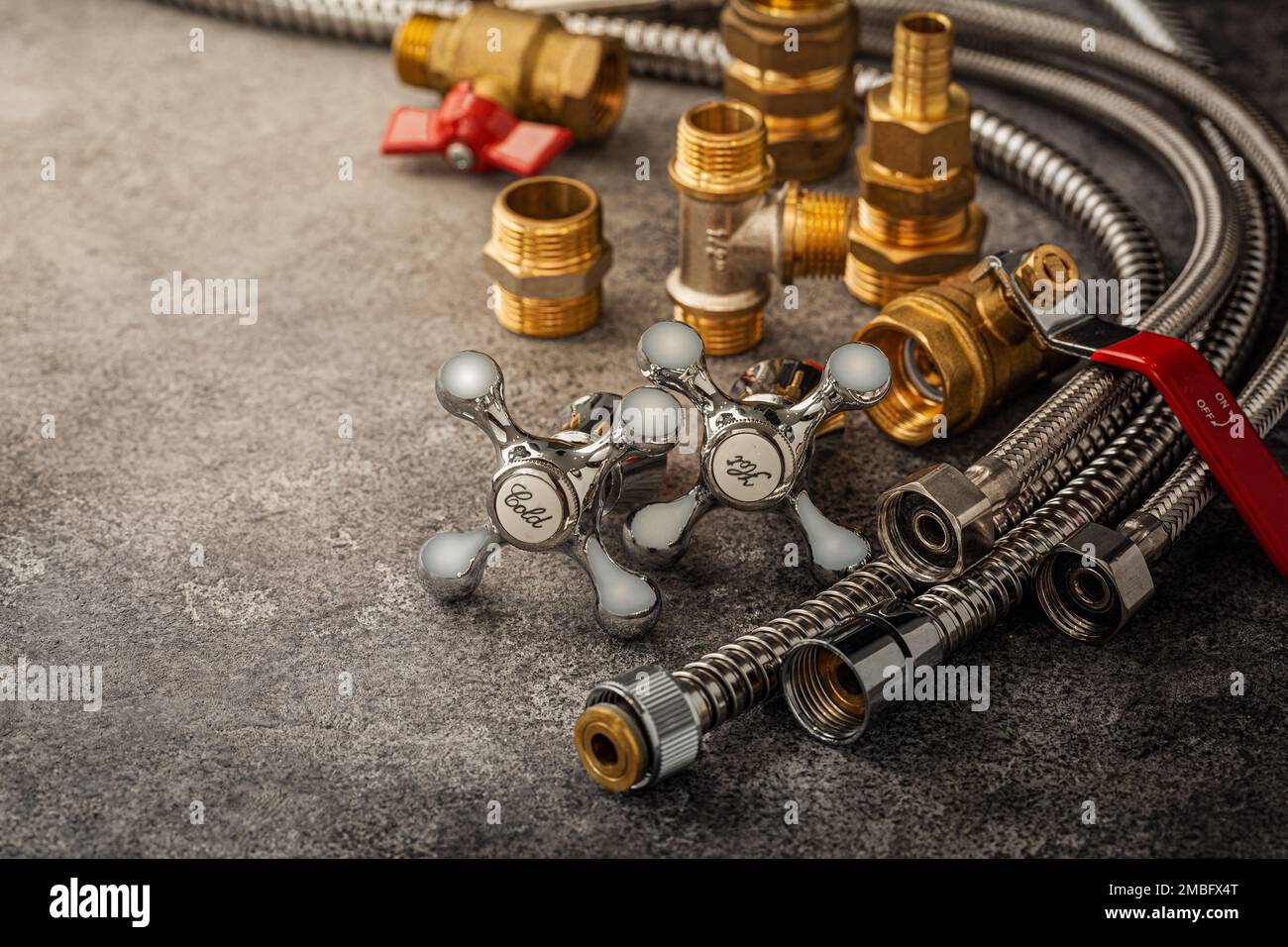 Bathroom Flexible Hoses Pipes And Brass Pipe Fixtures Fittings On Dark Background Stock Photo