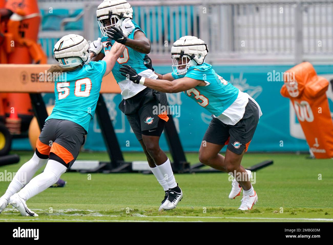 Miami Dolphins linebacker Cameron Goode (53) runs with the football against  teammate defensive end Big Kat Bryant (56) during NFL football training  camp at Baptist Health Training Complex in Hard Rock Stadium