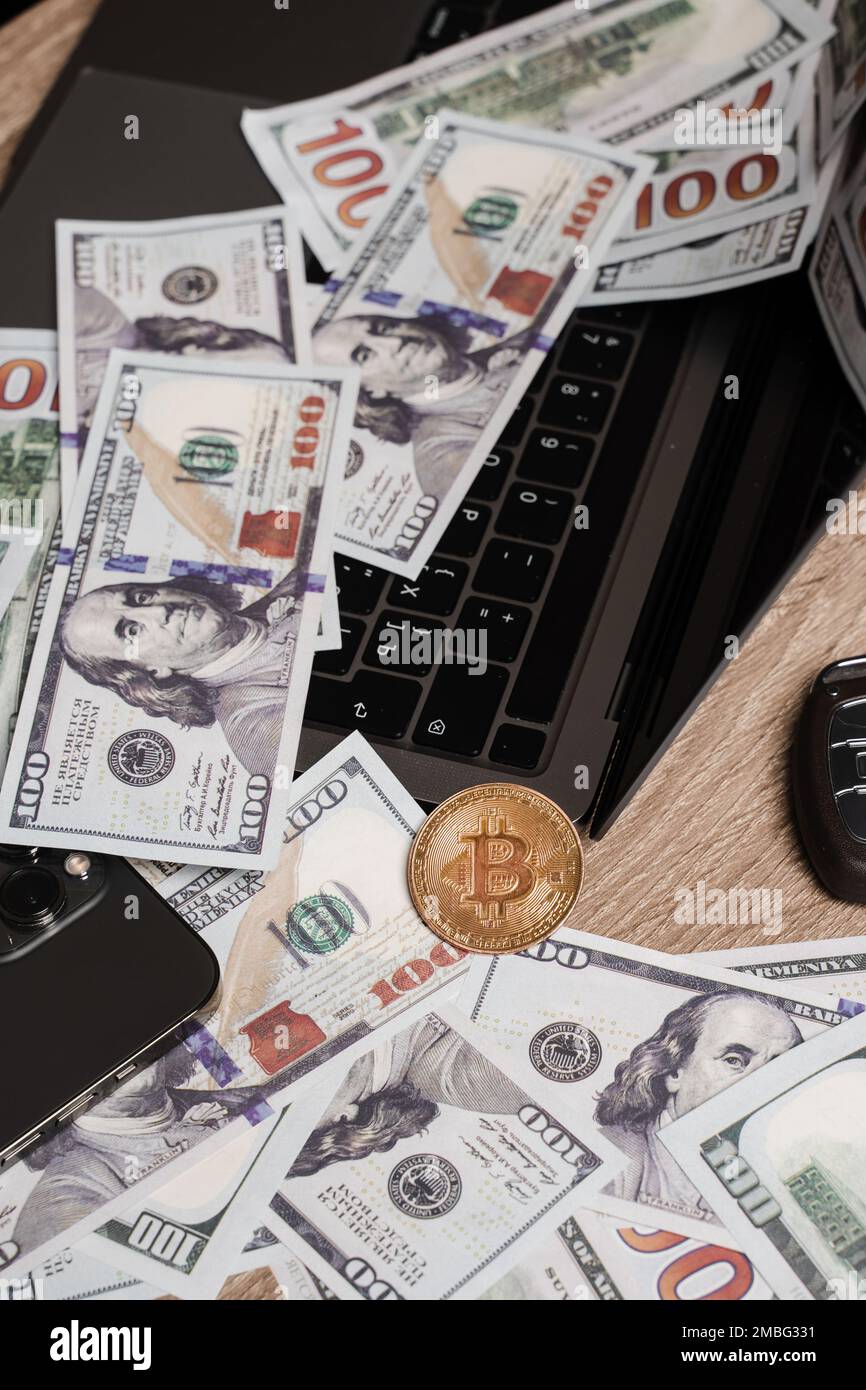 Golden coin bitcoin and dollars on laptop on the table of wealthy crypto  trader. Rich investor with large amount of cash dollars and golden bitcoin  co Stock Photo - Alamy