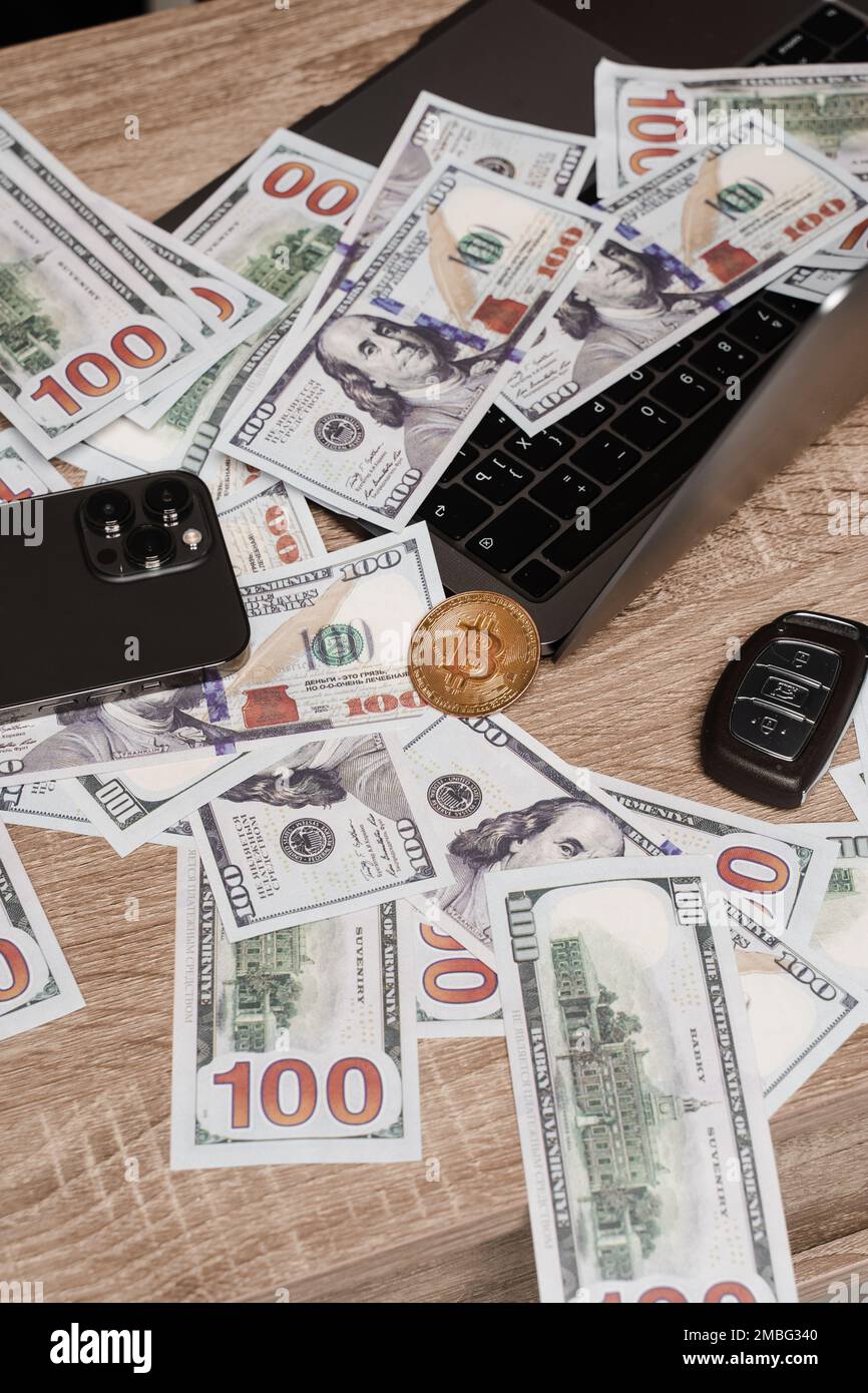 Rich investor with large amount of cash dollars and golden bitcoin coin.  Golden coin bitcoin and dollars on laptop on the table of wealthy crypto  trad Stock Photo - Alamy
