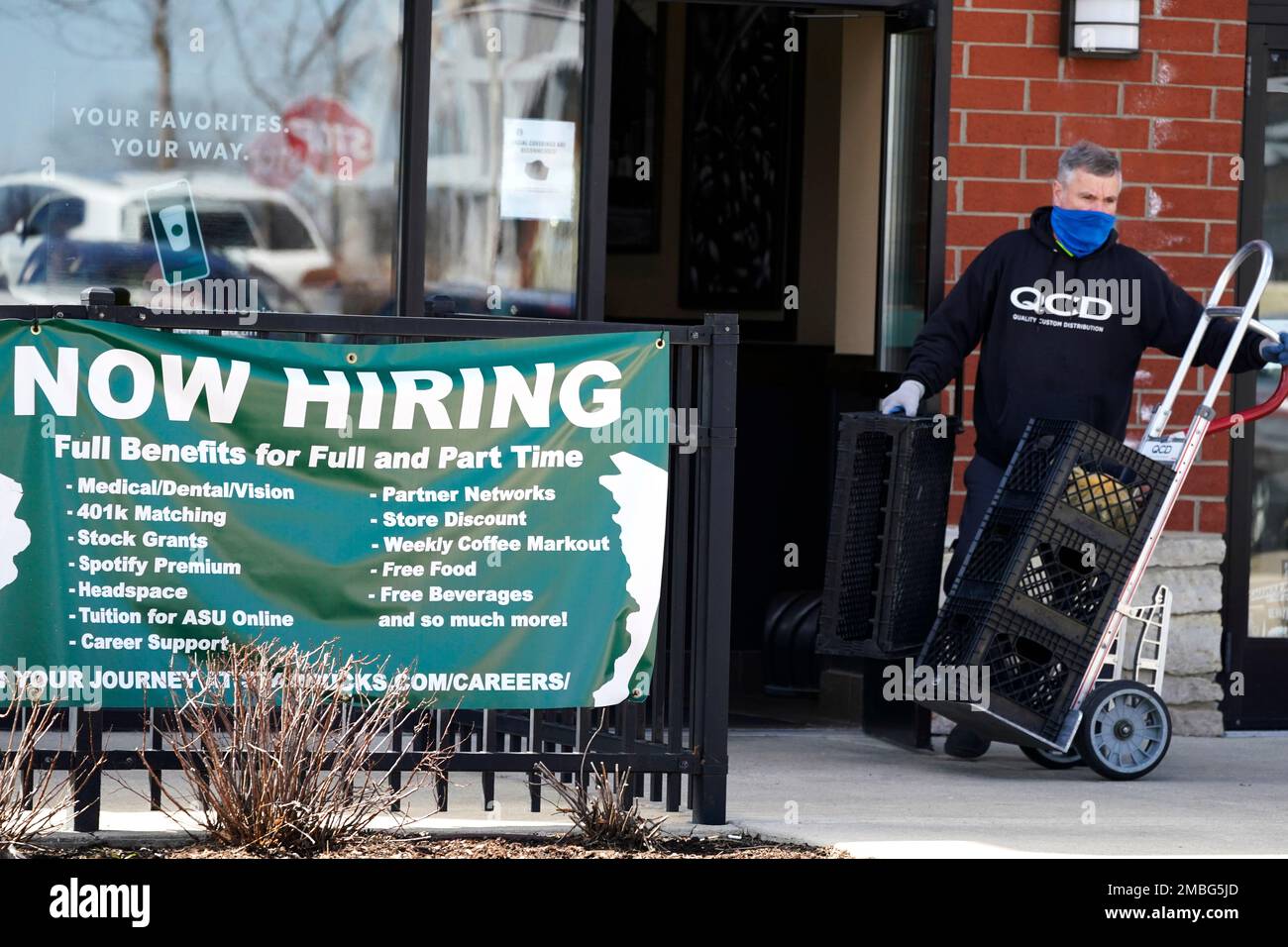 FILE - A hiring sign is displayed outside of a Starbucks in 