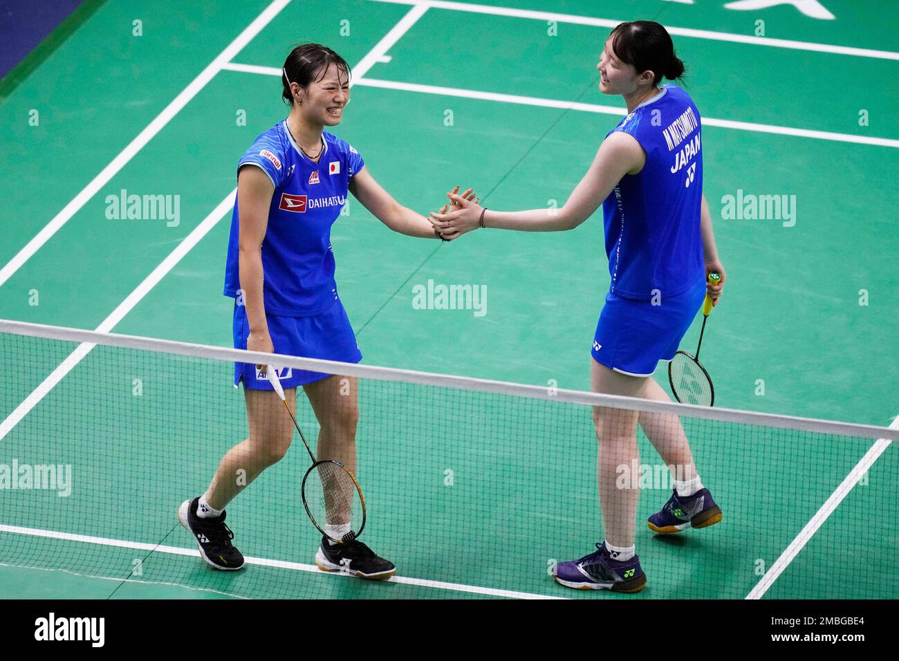Japans Yuki Fukushima, left, and Mayu Matsumoto react after winning a point against Lanny Tria Mayasari and Jesita Puti Miantoro during their womens double qualifying match at Thomas and Uber Cup in