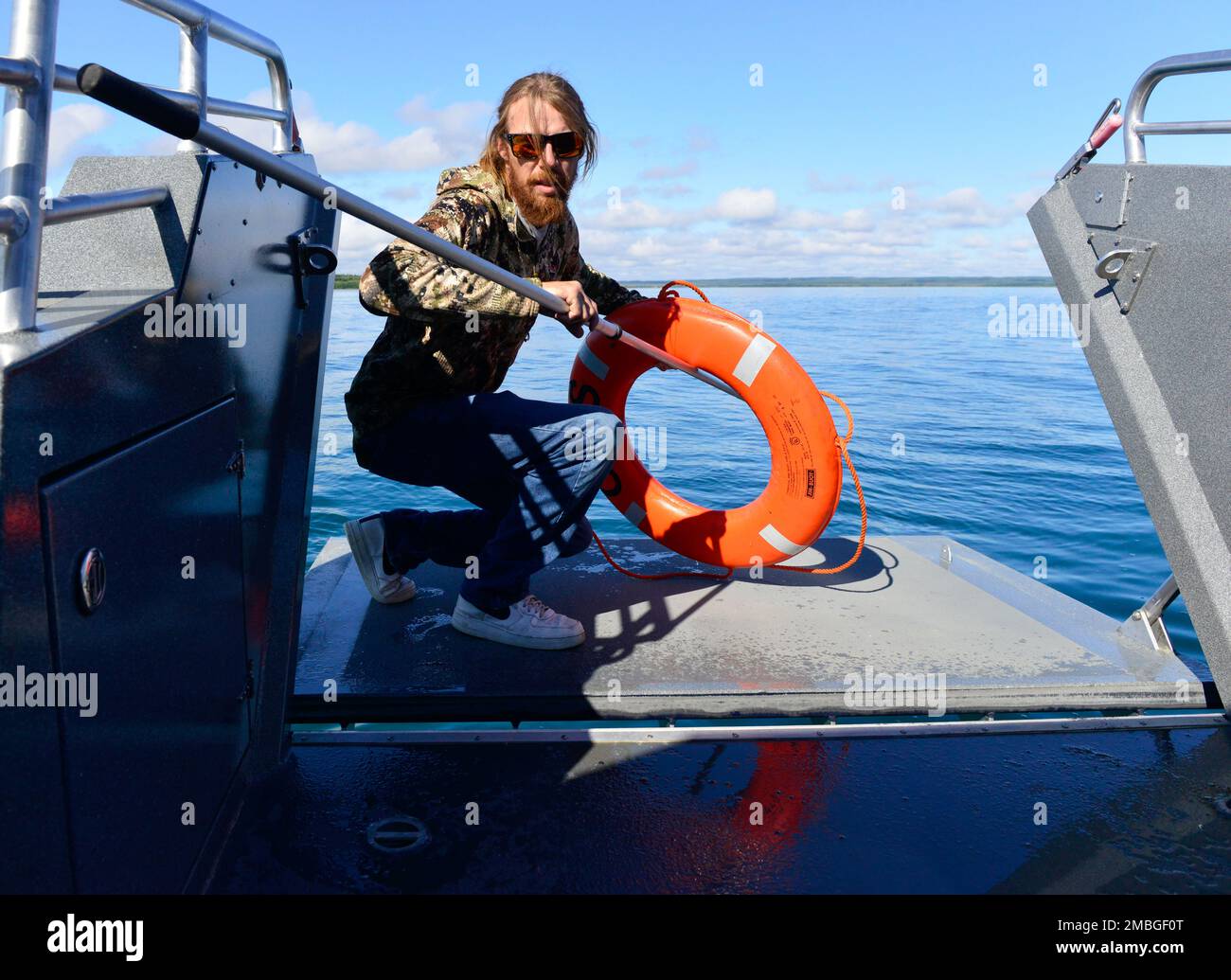 https://c8.alamy.com/comp/2MBGF0T/bo-anderson-a-deckhand-aboard-passenger-vessel-otis-retrieves-a-life-ring-from-the-water-during-a-man-overboard-drill-while-underway-on-naknek-river-in-naknek-alaska-june-15-2022-inspectors-with-sector-anchorages-marine-safety-task-force-conducted-inspections-and-commercial-fishing-vessel-exams-throughout-the-bristol-bay-region-june-13-24-u-s-coast-guard-photo-by-petty-officer-2nd-class-melissa-e-f-mckenzie-2MBGF0T.jpg