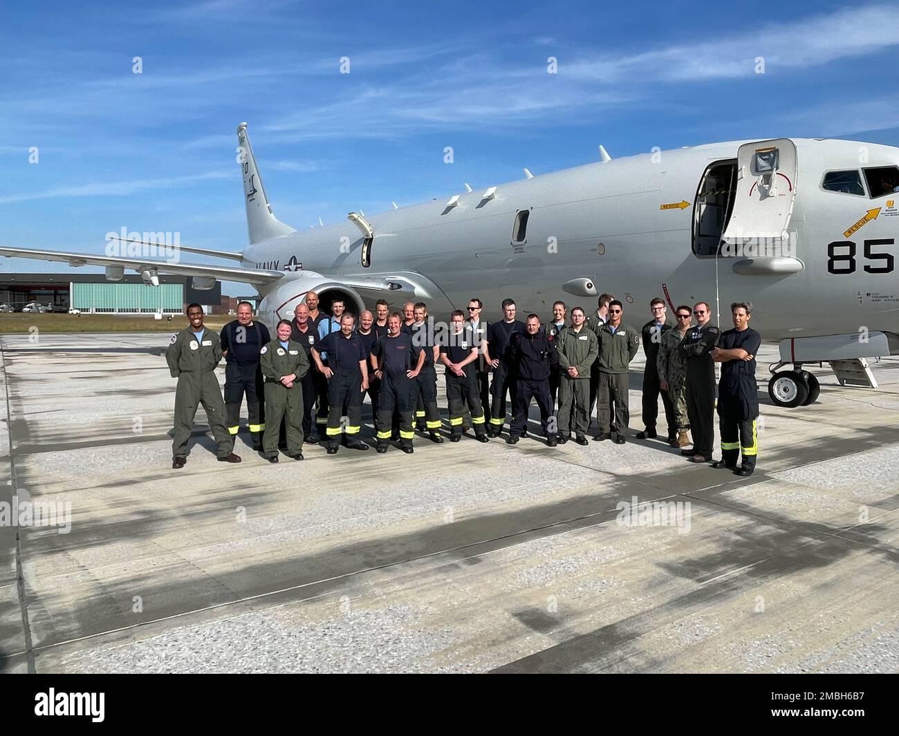 Members of Combat Air Crew Six (CAC-6) pose outside of the P-8A along with with members of the Nordholz Fire and Rescue Command. Stock Photo