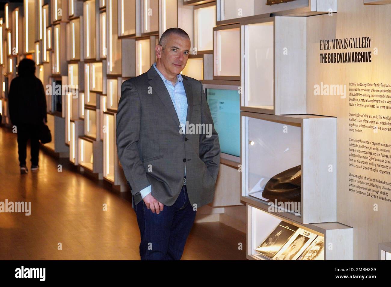 Steven Jenkins, director of the Bob Dylan Center and archive, poses for a  photo at the archive wall, Thursday, May 5, 2022, in Tulsa, Okla. The  center offers an immersive film experience,, image size:1300x956