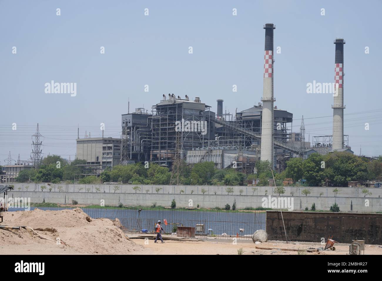 A worker of Sabarmati riverfront development project walks past a