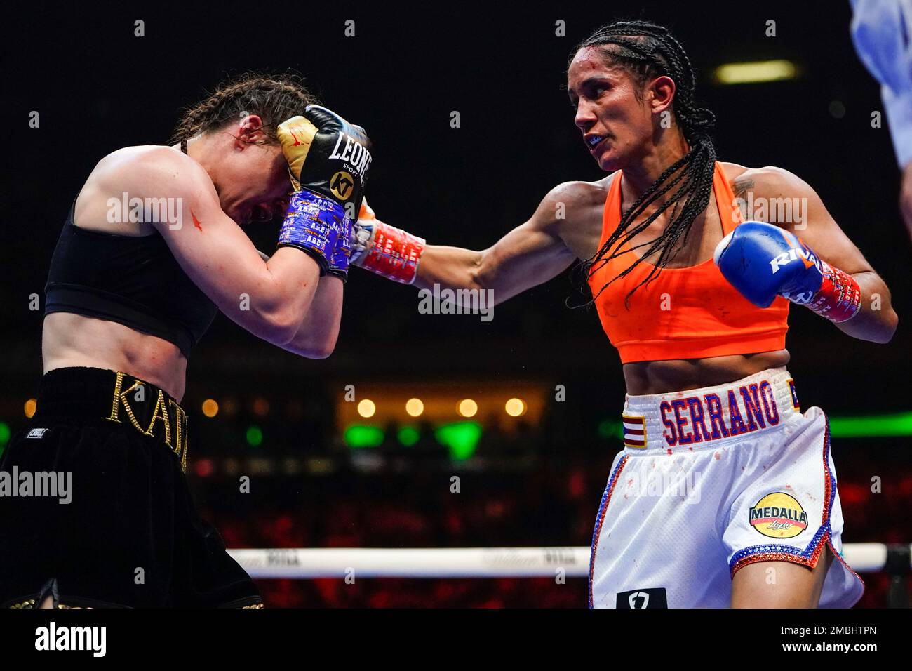 Amanda Serrano, right, punches Ireland's Katie Taylor during the sixth