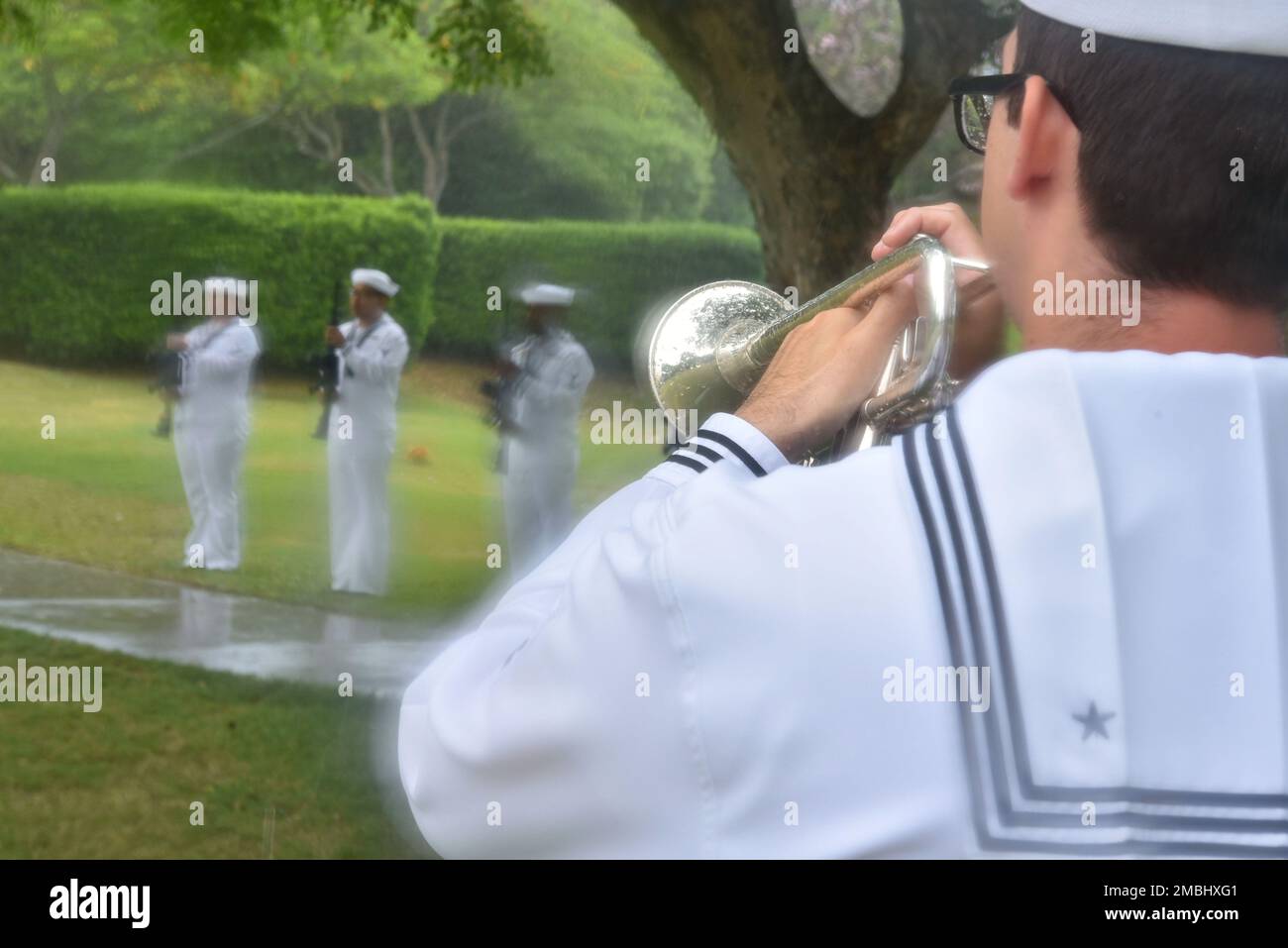 A Sailor assigned to U.S. Navy Region Hawaii plays Taps during an internment ceremony for U.S. Navy Machinist's Mate 2nd Class Everett Raymond Stewart, of California, at the National Memorial Cemetery of the Pacific, Honolulu, Hawaii, June 16, 2022. Stewart was assigned to the USS Oklahoma, which sustained fire from Japanese aircraft and multiple torpedo hits causing the ship to capsize and resulted in the deaths of more than 400 crew members on Dec. 7, 1941, at Ford Island, Pearl Harbor. Stewart was recently identified through DNA analysis by the Defense POW/MIA Accounting Agency (DPAA) foren Stock Photo