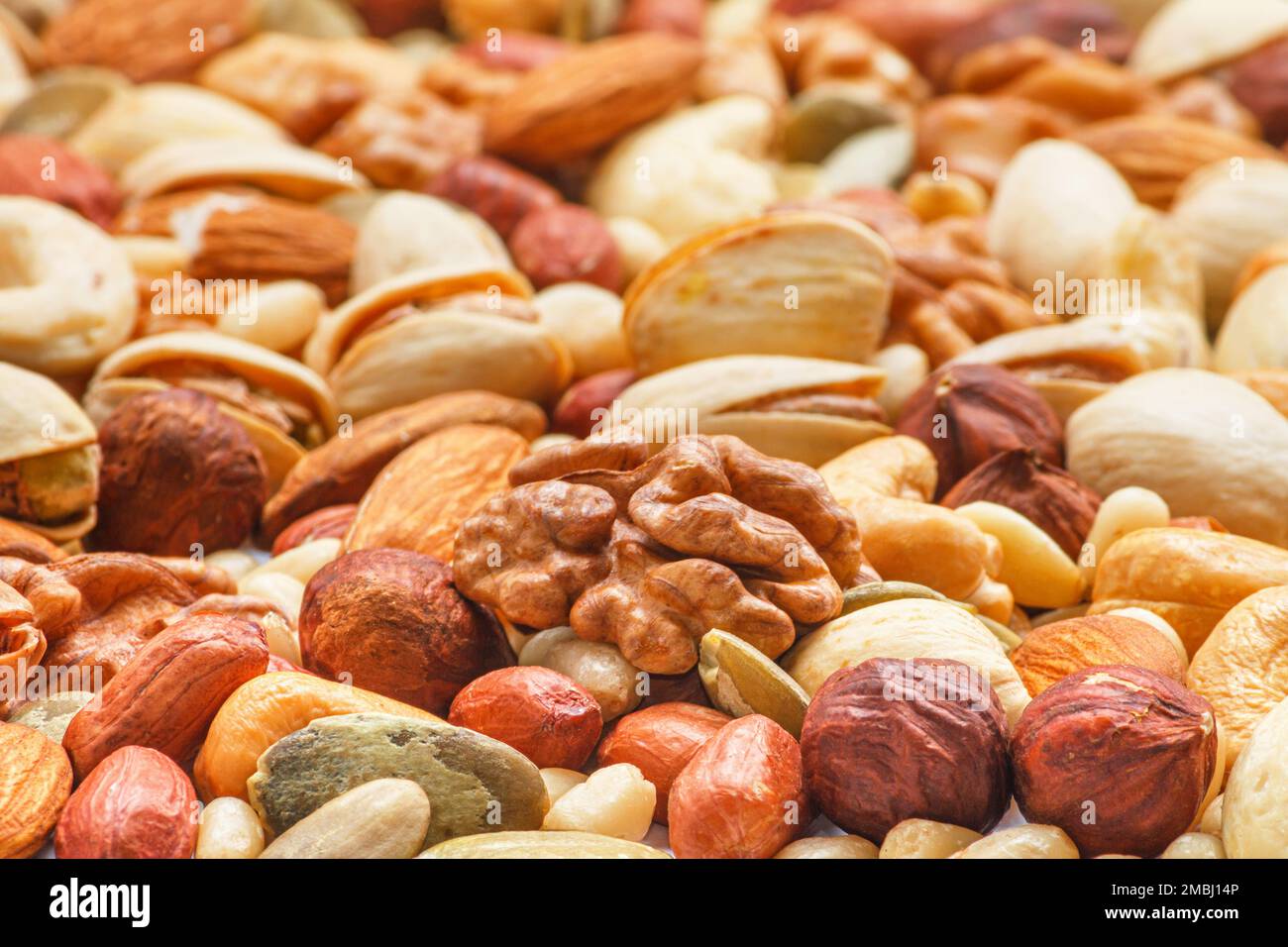 Different types of nuts and seeds, photo with selective focus. Peeled