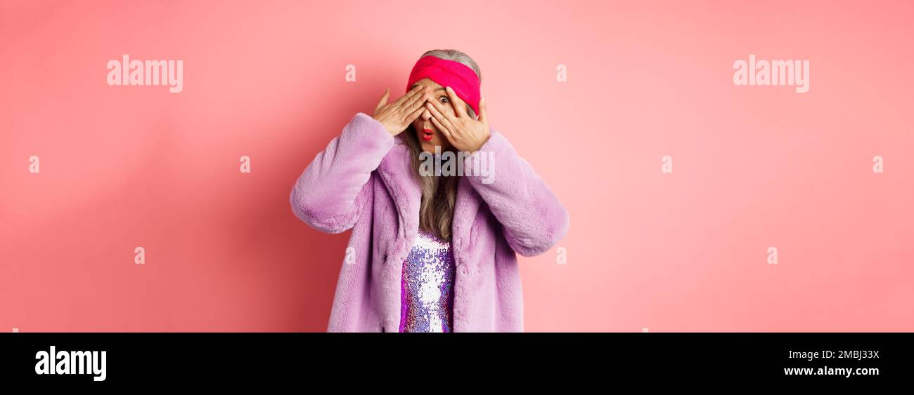 Fashion and shopping concept. Stylish asian hipster granny in purple