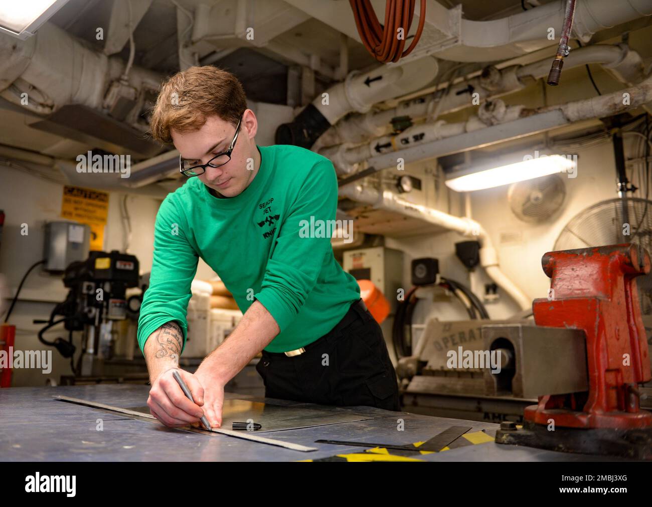 220616-N-FB730-1031 MEDITERRANEAN SEA (June 16, 2022) Aviation Structural Mechanic Airman Steven Knight, Charlotte, North Carolina, measures a steel plate in the jet shop aboard USS Harry S. Truman (CVN 75), June 16, 2022. The Harry S. Truman Carrier Strike Group is on a scheduled deployment in the U.S. Naval Forces Europe area of operations, employed by U.S. Sixth Fleet to defend U.S., allied and partner interests. Stock Photo