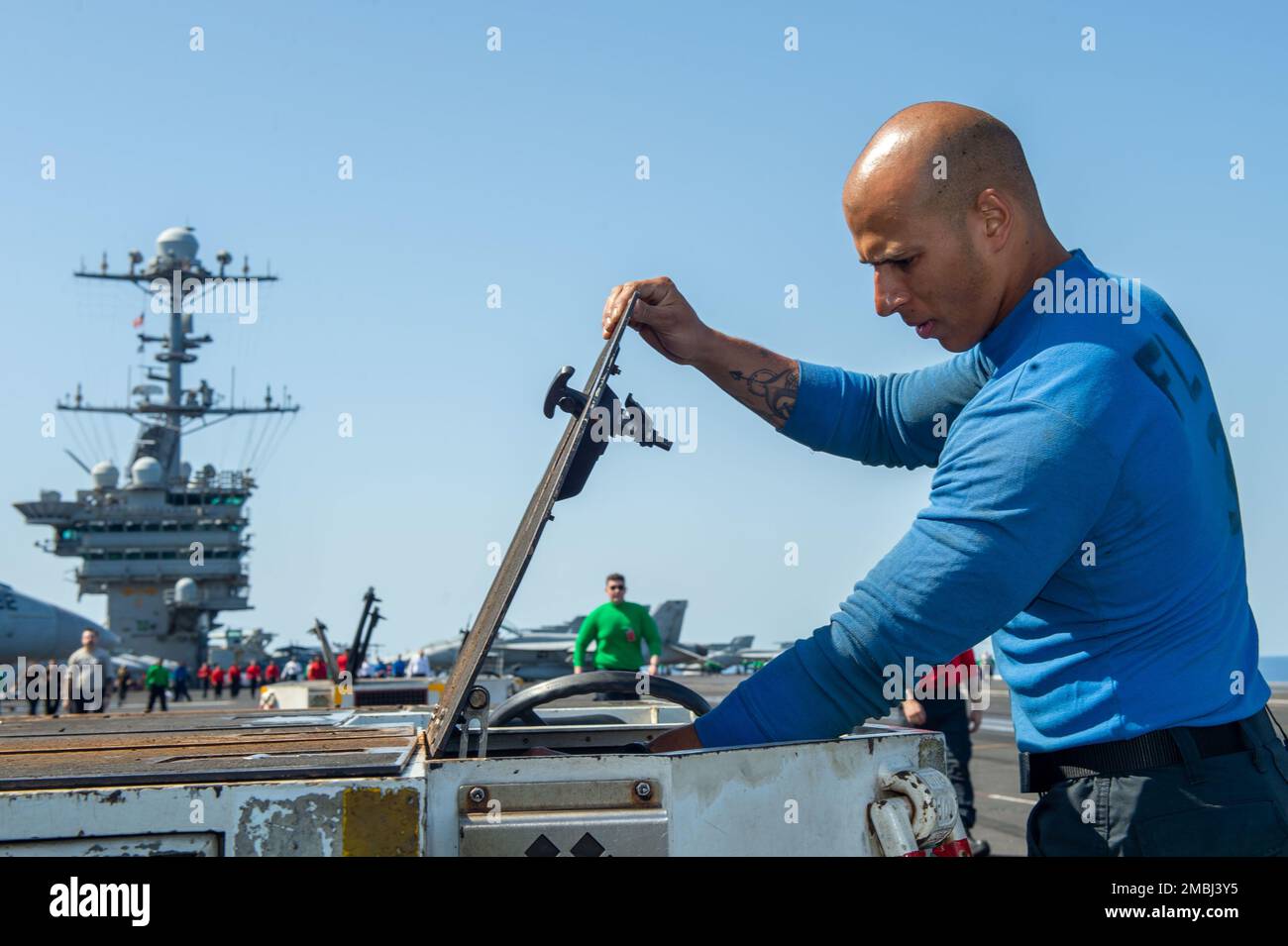 220616-N-GP384-1115 MEDITERRANEAN SEA (June 16, 2022) Aviation Boatswain's Mate (Handling) Airman Austin Campbell inspects a spotting dolly for foreign object debris on the flight deck of USS Harry S. Truman (CVN 75), June 16, 2022. The Harry S. Truman Carrier Strike Group is on a scheduled deployment in the U.S. Naval Forces Europe area of operations, employed by U.S. Sixth Fleet to defend U.S., allied and partner interests. Stock Photo