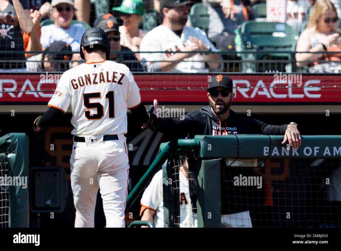 San Francisco Giants' Luis Gonzalez, left, is congratulated by manager Gabe  Kapler, right, after he scored against the Washington Nationals during the  fifth inning of a baseball game in San Francisco, Saturday