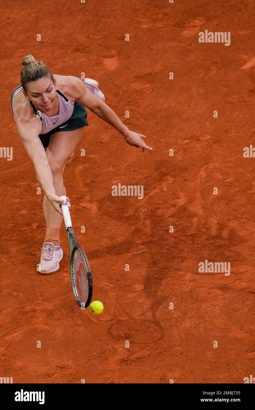 Simona Halep, of Romania, returns the ball against Paula Badosa of Spain during their match at the Mutua Madrid Open tennis tournament in Madrid, Spain, Saturday, April 30, 2022