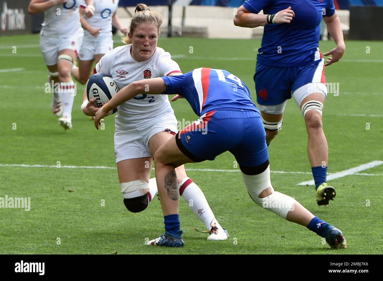 England's Lydia Thompson, left, is tackled by France's Caroline Boujard
