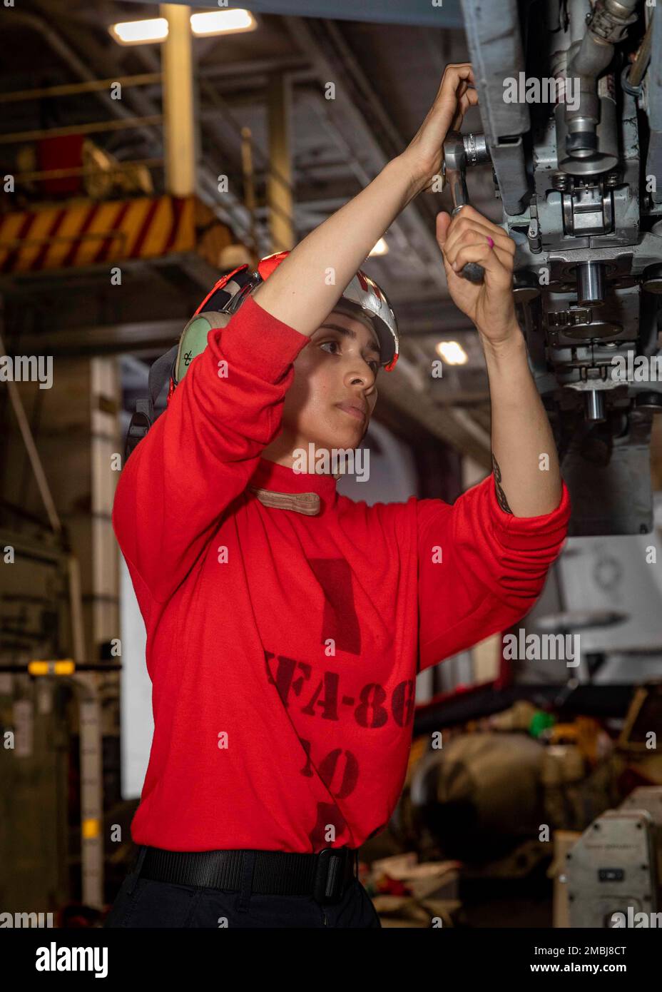 220616-N-OL632-1007 ATLANTIC OCEAN (June 16, 2022) Aviation Ordnanceman 3rd Class Jesika Celis, assigned to Strike Fight Squadron (VFA) 86, tightens bolts on an F/A-18E Super Hornet aircraft aboard the Nimitz-class aircraft carrier USS George H.W. Bush (CVN 77), June 16, 2022. The George H.W. Bush Carrier Strike Group (CSG) is underway completing a certification exercise to increase U.S. and allied interoperability and warfighting capability before a future deployment. The George H.W. Bush CSG is an integrated combat weapons system that delivers superior combat capability to deter, and if nece Stock Photo
