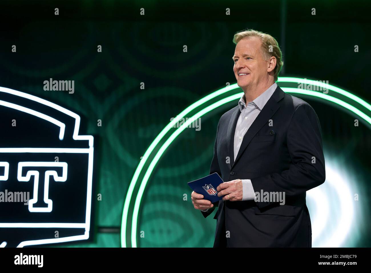 NFL Commissioner Roger Goodell walks on stage with a pick during the