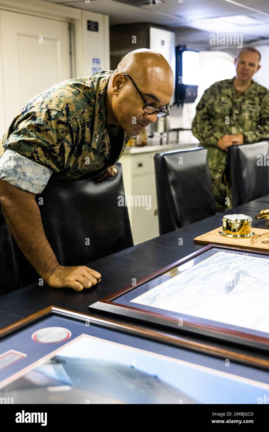 U.S. Marine Corps Maj. Gen. Brian Cavanaugh, commanding general, 1st Marine Aircraft Wing, looks at a portrait of the Arleigh Burke-class guided-missile destroyer USS Frank E. Petersen, Jr. (DDG 121), during a tour of the ship, Joint Base Pearl Harbor-Hickam, Hawaii, June 16, 2022. The USS Frank E. Petersen, Jr. is named after retired U.S. Marine Corps Lt. Gen. Frank E. Petersen, Jr., who was the first Black U.S. Marine Corps aviator and the first Black Marine to become a three-star general. Stock Photo
