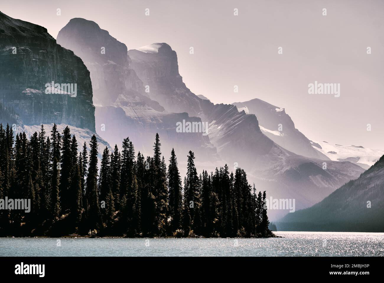 Jagged, glaciated peaks with steep slopes down into stands of